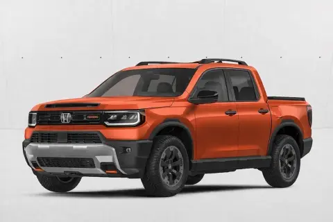 Pomarańczowy Honda Ridgeline z czarnymi akcentami i relingami dachowymi, gotowy na przygodę.