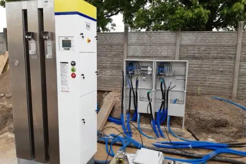 Nowe stacje CNG w Warszawie w trakcie budowy. Widać nowoczesne dystrybutory i skrzynki elektryczne z przewodami.