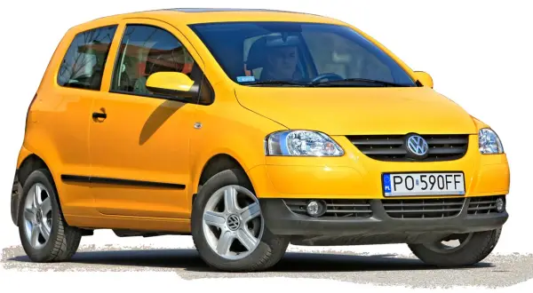 Żółty Volkswagen Fox z polskimi tablicami PO 590FF, gotowy do jazdy.