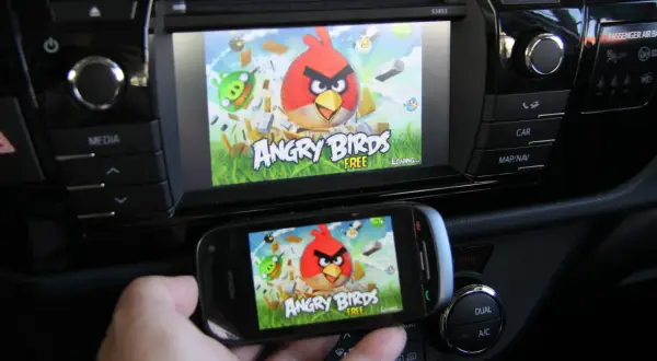 Gra Angry Birds na ekranie telefonu i samochodowego systemu multimedialnego. Działa jako mirror link, przenosząc rozgrywkę na większy ekran.