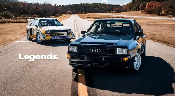 Dwa kultowe Audi quattro S1 na drodze. Jeden w barwach rajdowych, drugi czarny, lśniący.