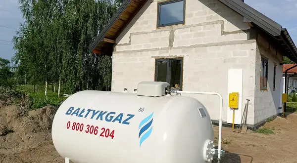 Duży zbiornik na gaz LPG przed budowanym domem. Zastanawiasz się, ile waży gaz LPG? Ten zbiornik czeka na wypełnienie.