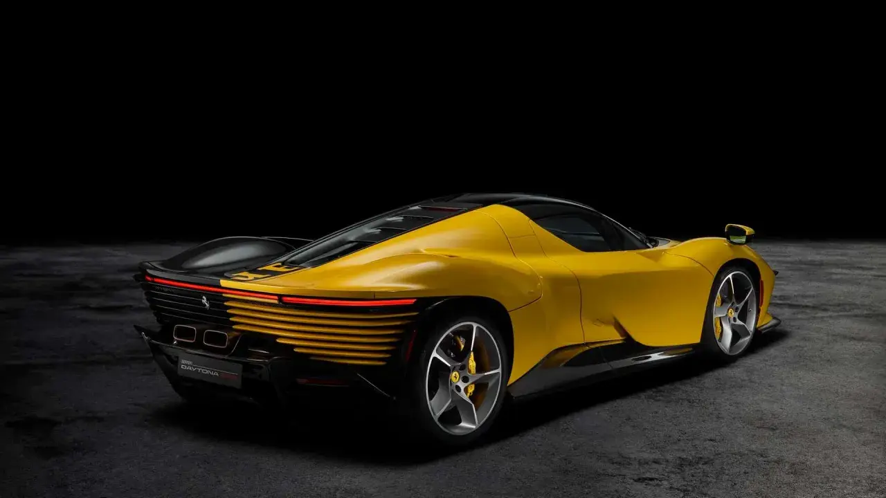 Żółty Ferrari Daytona z czarnym dachem i detalami, prezentujący swoje sportowe linie na ciemnym tle.