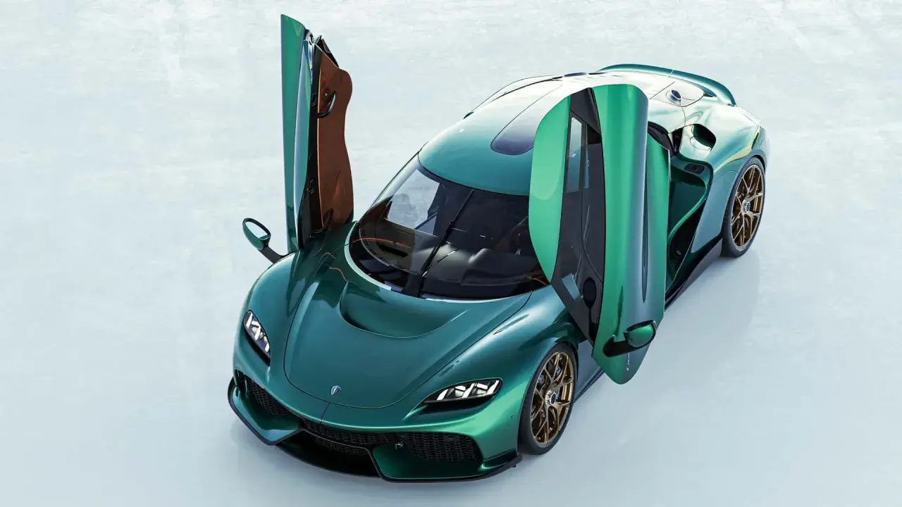 Zielony Koenigsegg Gemera z otwartymi drzwiami, prezentujący swoje luksusowe wnętrze i sportowy design.