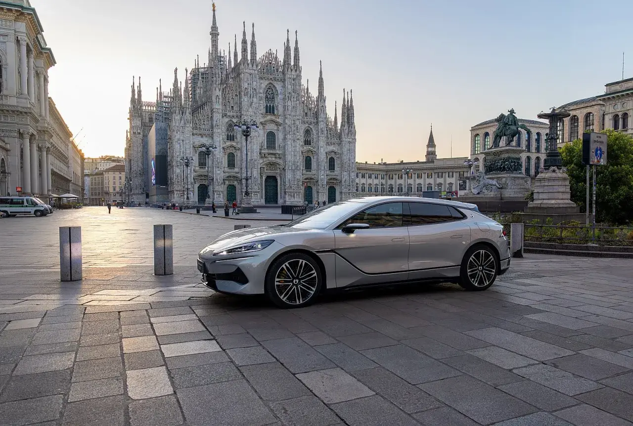 Srebrny Denza Z9 GT na tle Katedry Duomo w Mediolanie. Sprawdź aktualną denza z9 gt cena!