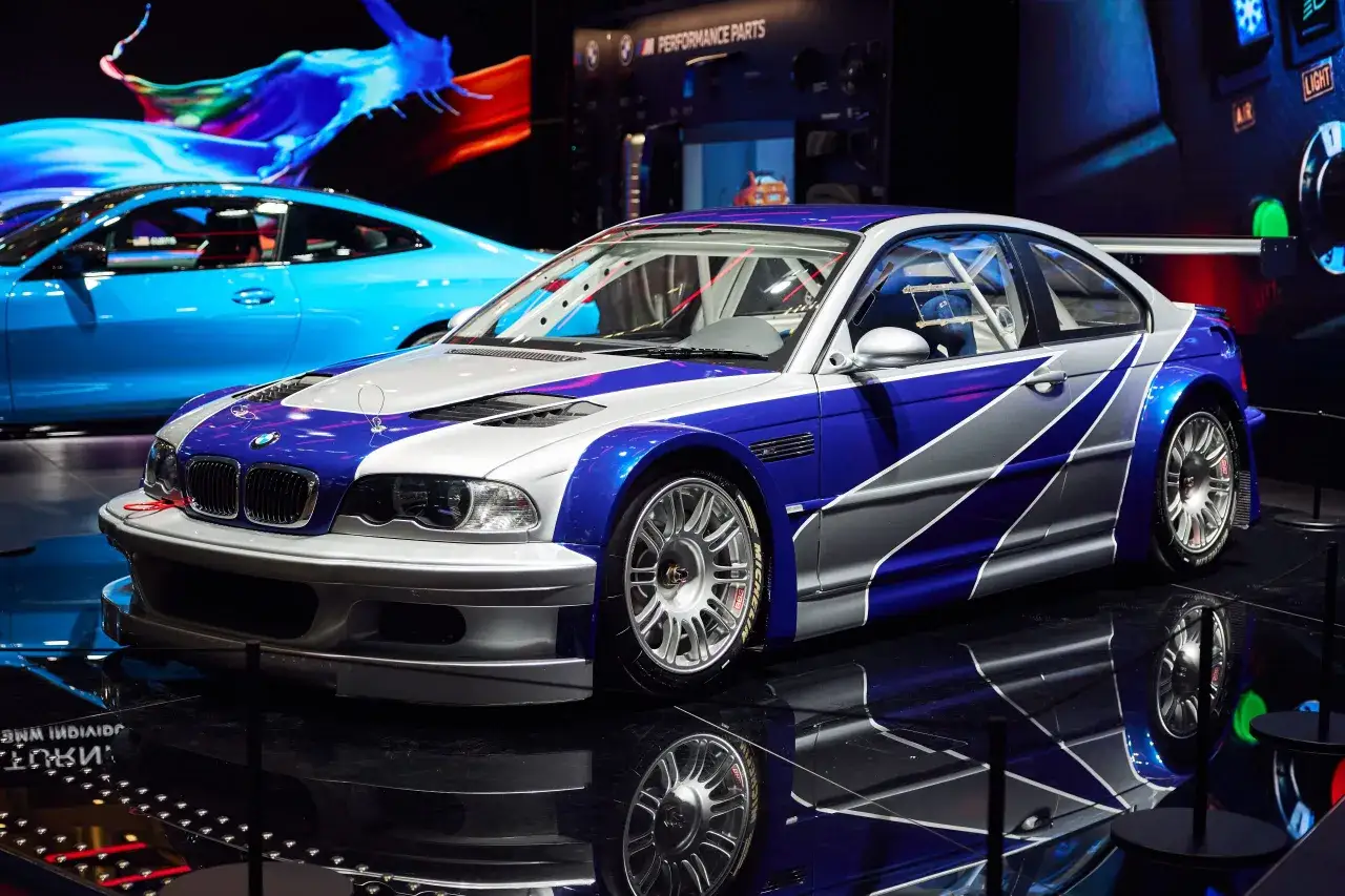Wyścigowe BMW M3 GTR w niebiesko-srebrnych barwach, gotowe do akcji.
