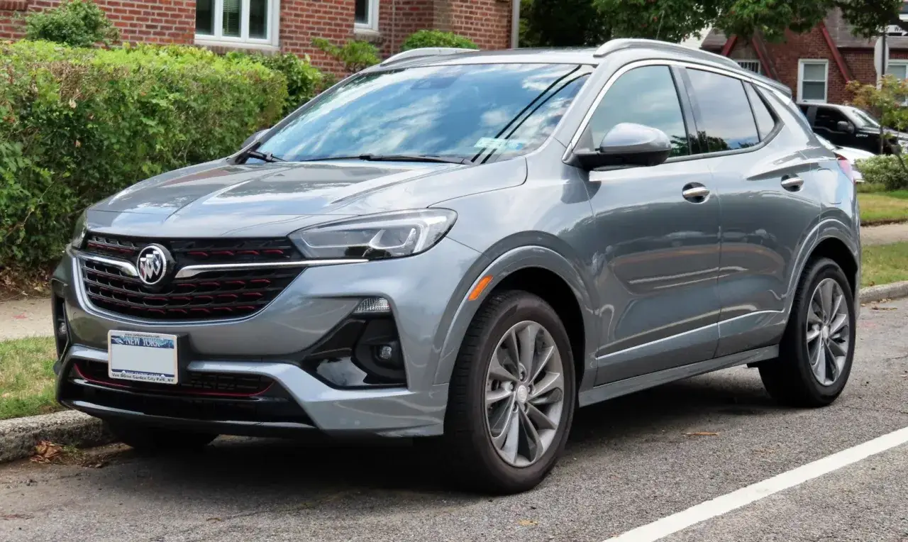 Szary Buick Encore z czerwonymi akcentami na grillu stoi zaparkowany przy ulicy.